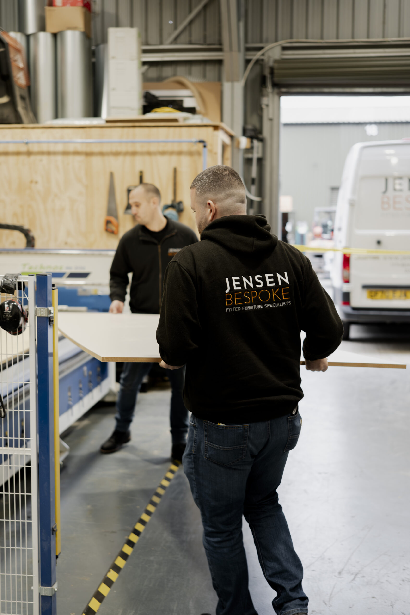 Jensen Bespoke team member in warehouse working with wood