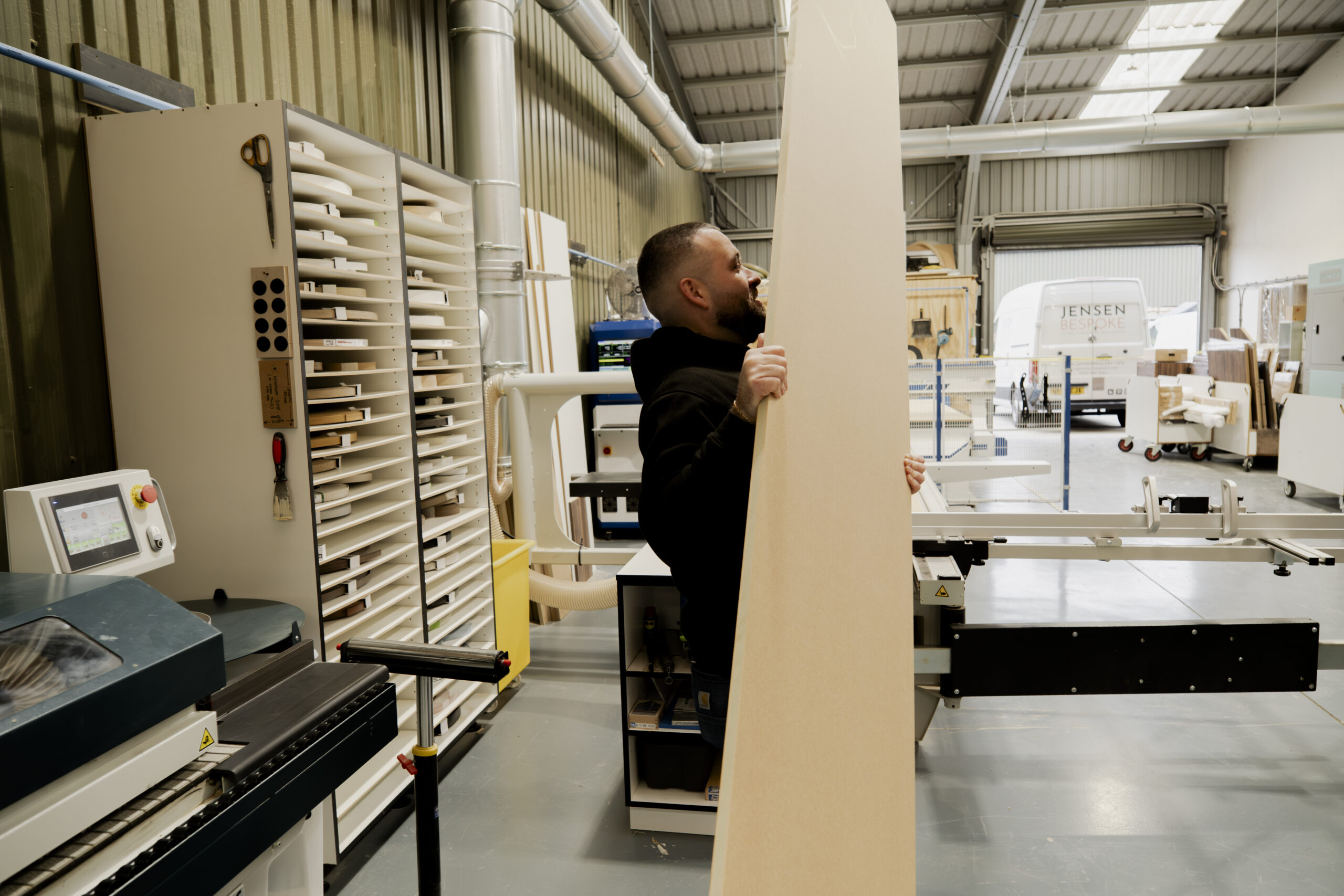 jensen bespoke team member in warehouse working with wood