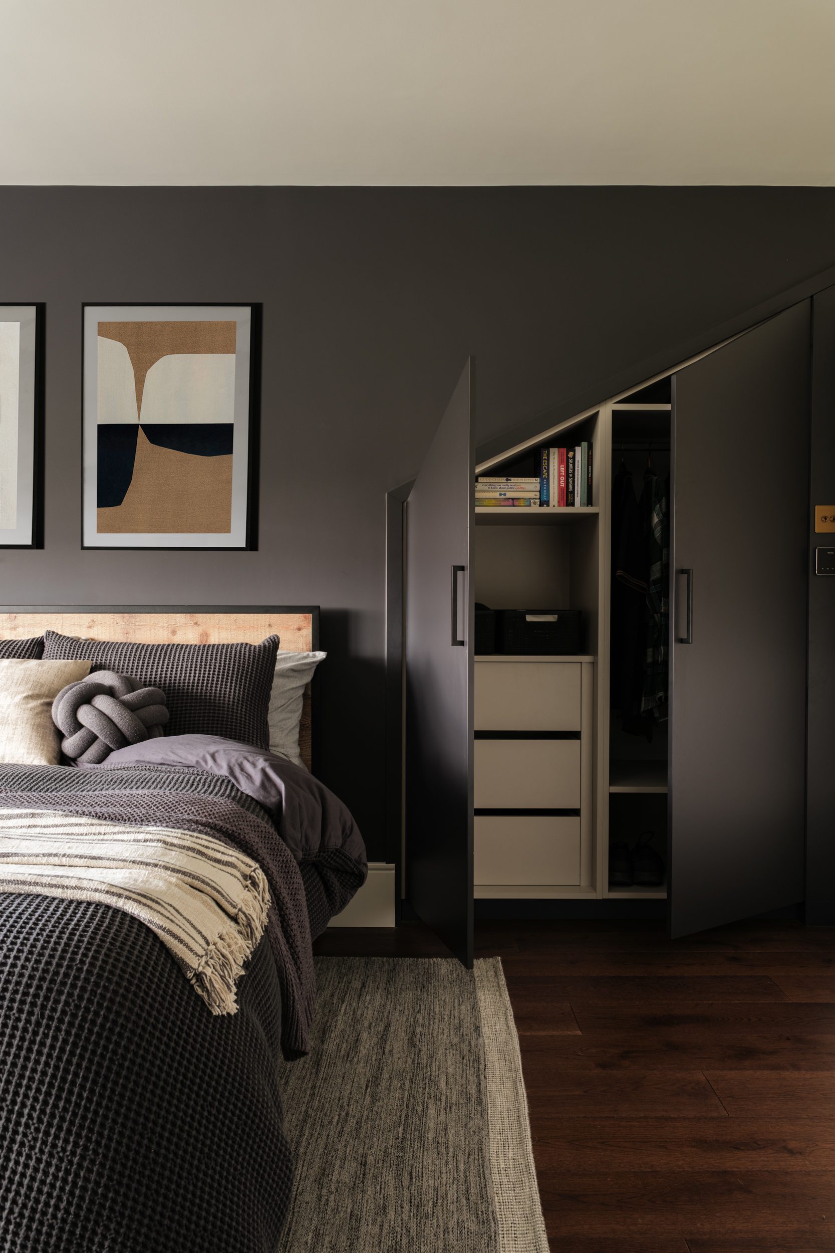 Dark bedroom with angled wardrobes
