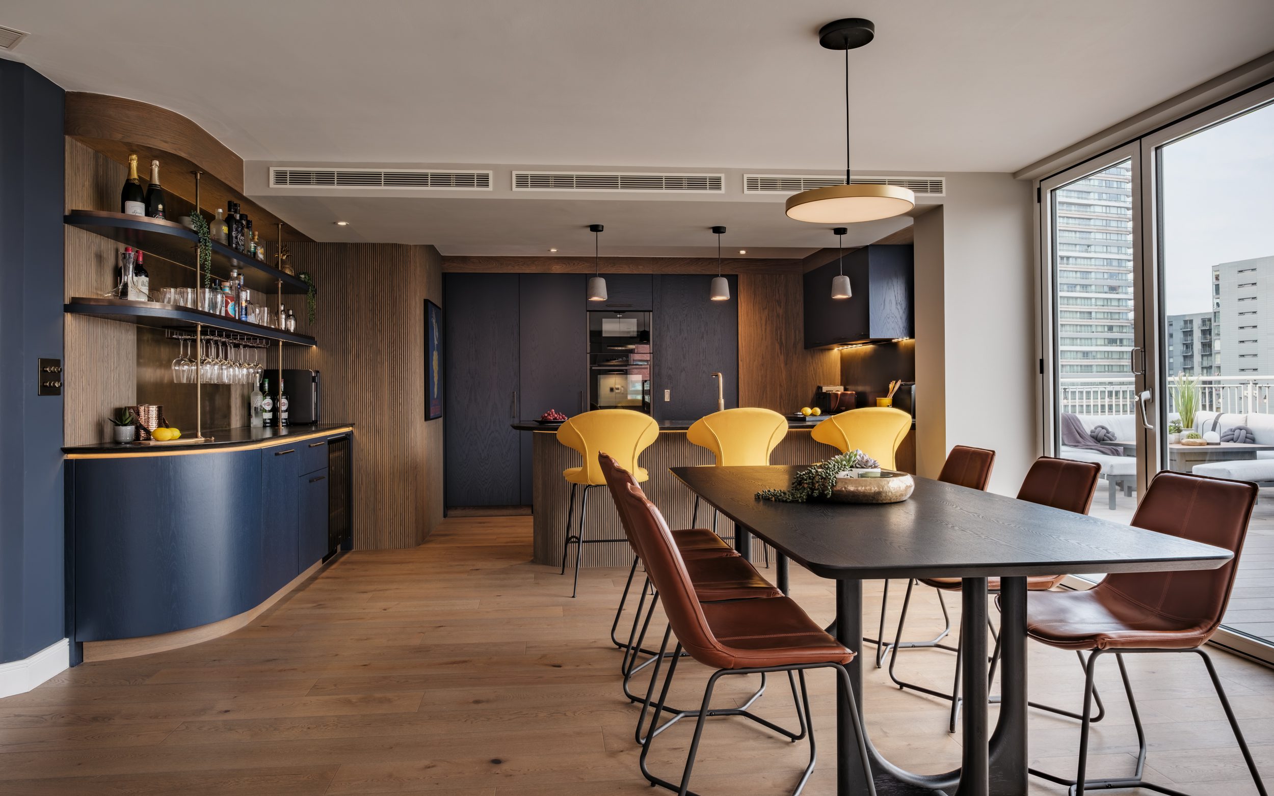 Light-filled bespoke kitchen with handleless cabinetry and integrated dining space
