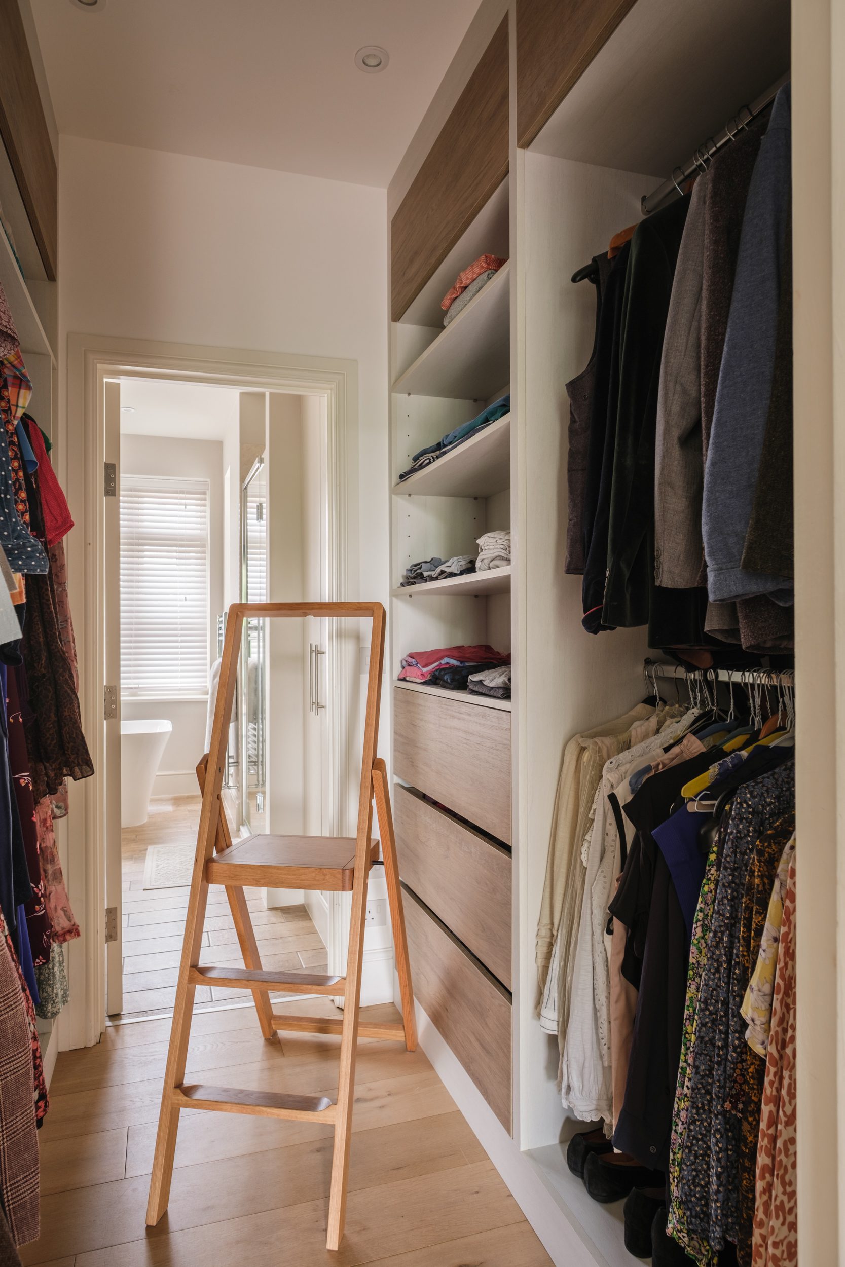 Stylish walk in wardrobe with beautifully hand crafted wardrobe doors