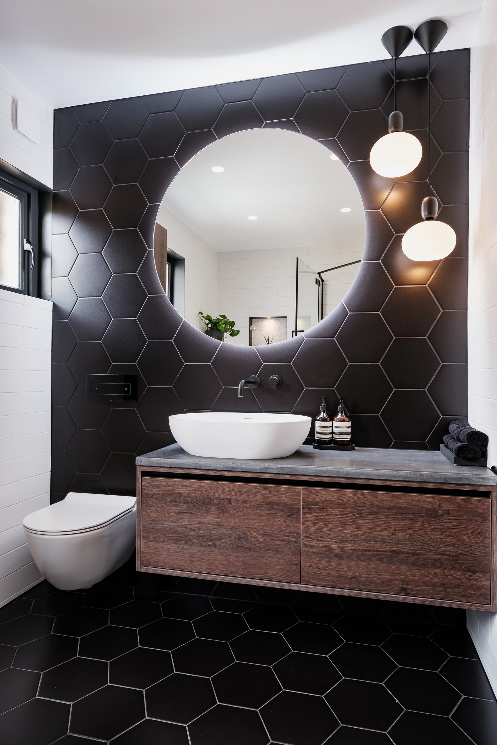Dark bathroom with hexagonal tiles