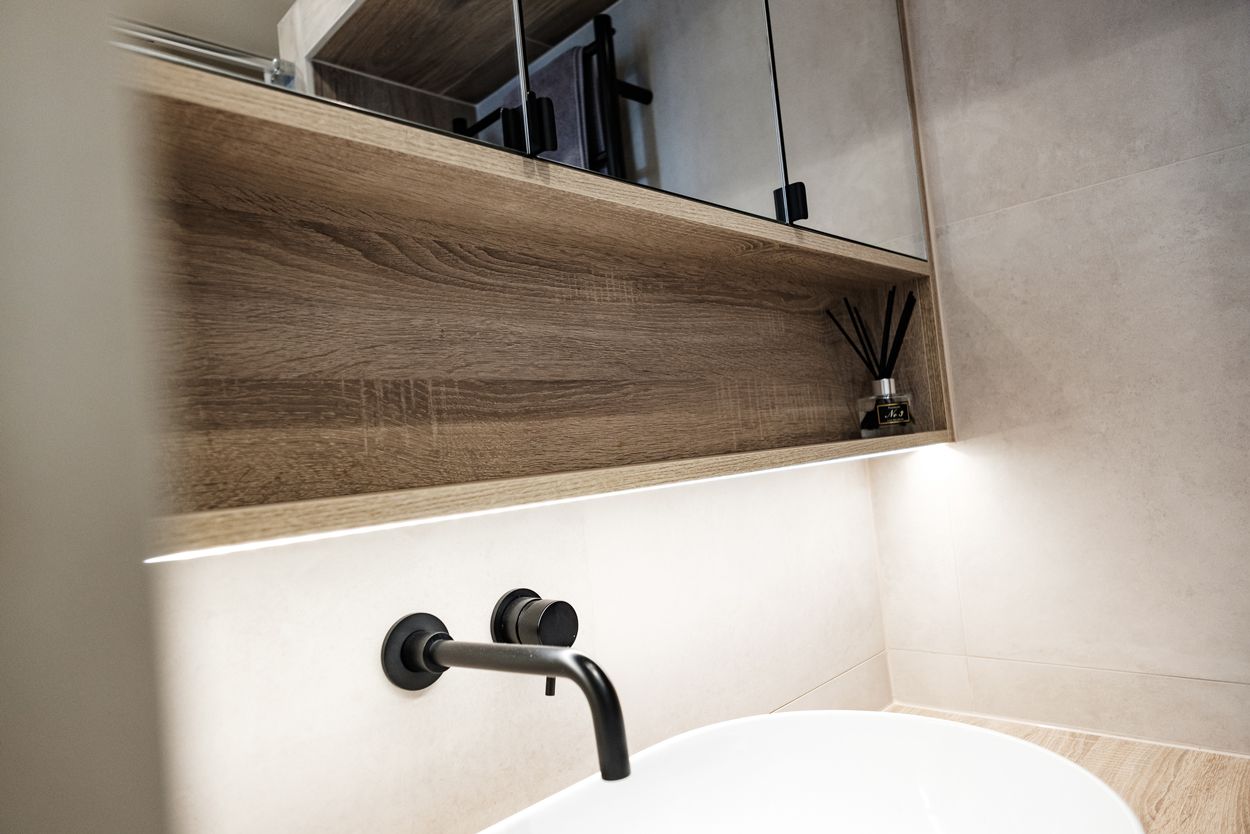 Modern bathroom with wooden shelf